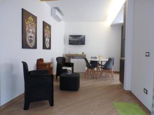 a living room with a table and chairs at Two-room Marina Apartment Near the Sea Climate - Wi-fi in Avola