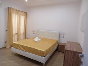 a bedroom with a bed with a teddy bear on it at Two-room Marina Apartment Near the Sea Climate - Wi-fi in Avola