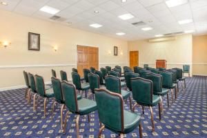 an empty room with green chairs in a room at Red Roof Inn & Suites Newport News in Newport News