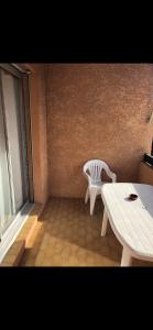 a room with a table and a bench and a window at Studio Saint Cyr sur mer in Saint-Cyr-sur-Mer