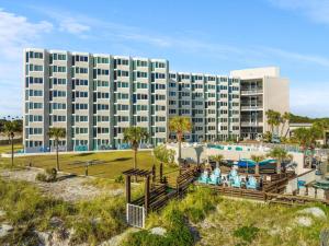 a large building with a pool and a resort at Top of the Gulf 410 - Beach Front Resort Condo - RENOVATED LIKE NEW in Panama City Beach