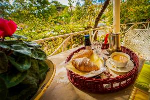 a basket of bread and a cup of coffee on a table at La casa dei Paggi in Sestri Levante