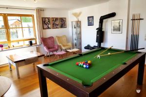 a living room with a pool table at Ferienwohnungen Schönwetter Oberpfaffenhofen in Weßling