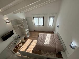 a bedroom with a bed and a couch in a room at Camera privata in Villa Paola in Pula