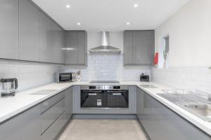 a white kitchen with white counter tops and appliances at Luxury York Stay,Mini Hotel, Hartlepool City Centre in Hartlepool