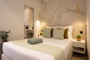 ein Schlafzimmer mit einem großen weißen Bett mit weißer Bettwäsche in der Unterkunft Le 34 in Saint-Tropez