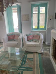 a living room with two chairs and a glass floor at Galatea House First floor with terraces in Káto Klísma