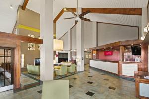 a lobby of a restaurant with a bar and chairs at Red Roof Inn & Suites Irving - DFW Airport South in Irving