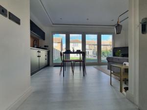 a kitchen and living room with a table and chairs at Stunning 1 King bed cabin in Grays in Grays Thurrock