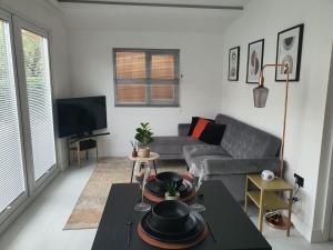 a living room with a couch and a table at Stunning 1 King bed cabin in Grays in Grays Thurrock