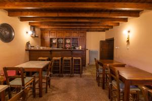a dining room with wooden tables and chairs at Troas Traditional Guesthouse in Vitsa
