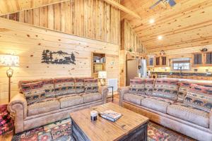 a living room with couches and tables in a cabin at Dog-Friendly Cabin with Fire Pit and Hot Tub! in Murphy