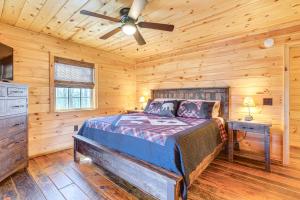 a bedroom with a bed and a ceiling fan at Dog-Friendly Cabin with Fire Pit and Hot Tub! in Murphy