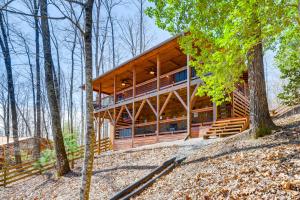 a large wooden house in the woods at Dog-Friendly Cabin with Fire Pit and Hot Tub! in Murphy