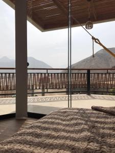 a bedroom with a view of a mountain at Dama Suites & Spa in Cieneguilla