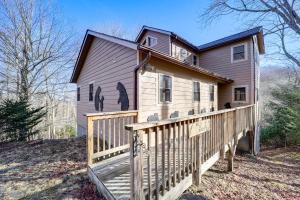 a house with a wooden fence in front of it at 1 Mi to Beech Mtn Skiing: Family Cabin w/ Fire Pit in Beech Mountain