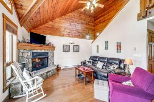a living room with a couch and a fireplace at 1 Mi to Beech Mtn Skiing: Family Cabin w/ Fire Pit in Beech Mountain