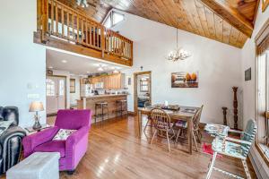 a living room with a purple couch and a table at 1 Mi to Beech Mtn Skiing: Family Cabin w/ Fire Pit in Beech Mountain