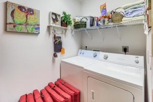 a laundry room with a washing machine and red towels at 1 Mi to Beech Mtn Skiing: Family Cabin w/ Fire Pit in Beech Mountain +23 photos