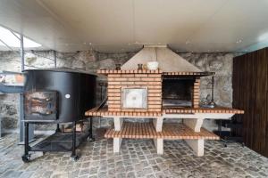 a brick fireplace with a stove in a room at Casa da Torre in Vieira do Minho
