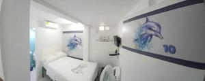Postel nebo postele na pokoji v ubytování Hotel Dmauro