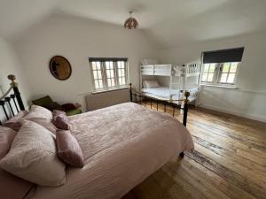 a bedroom with a bed with a teddy bear on it at Warren Farm Farmhouse nr Oxford in Culham