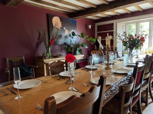 a dining room with a long wooden table with chairs at Warren Farm Farmhouse nr Oxford in Culham