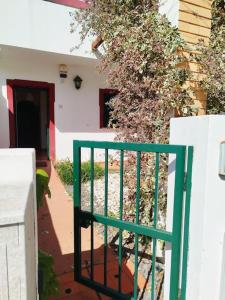 um portão verde em frente a uma casa em The South Sunny House - A Casa a Sul em Olhão