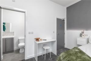 a bedroom with a bed and a sink and a toilet at Luxury York Stay,Mini Hotel, Hartlepool City Centre in Hartlepool