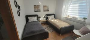 a bedroom with a bed and a bed and a window at Sweet Home in Wermelskirchen