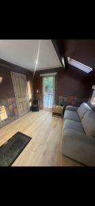 a large living room with a couch and a table at Lower batter farm in Huddersfield