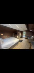 a bedroom with a large white bed in a room at Lower batter farm in Huddersfield