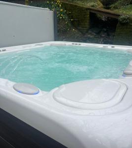 a jacuzzi tub with blue water in it at Lower batter farm in Huddersfield