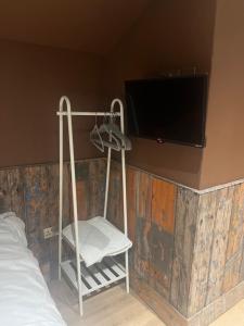 a room with a tv and a chair and a bed at Lower batter farm in Huddersfield +6 photos
