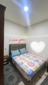 a bedroom with a bed with a sign that reads i love you at Tanger City in Tangier