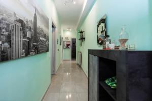 a hallway with a fireplace and paintings on the walls at Lotus - Appartamento sul Mare a Ostia con Giardino Relax in Lido di Ostia