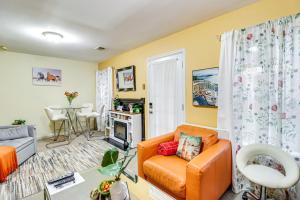 a living room with an orange couch and a table at Cozy Centreville Apt Close to Historic Sites in Centreville