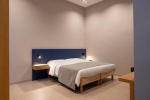 a bedroom with a large bed and a blue wall at Dimora Angioina in Naples
