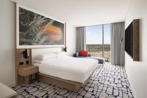 a hotel room with a bed and a large window at Courtyard by Marriott Perth Murdoch in Fremantle