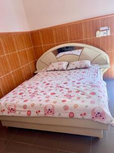 sypialnia z łóżkiem z różowymi kwiatami w obiekcie LAN168 w mieście Long Hai