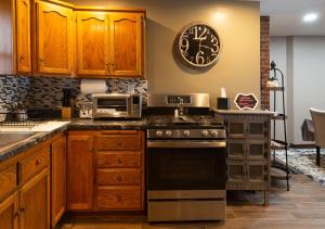 a kitchen with a stove and a clock on the wall at Near Sundown Mountain and Chestnut Mountain Resorts in Dubuque