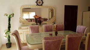 a dining room with a table and a mirror at Al Dora Residence Appartement in Hurghada
