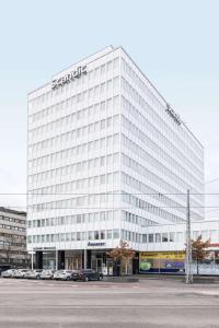 a large white building with a samsung sign on it at Scandic Meilahti in Helsinki
