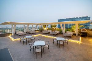 a patio with tables and chairs on top of a building at Radisson Blu Pune Hinjawadi in Pune