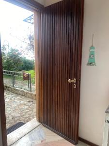 a wooden door in a room with a window at Casa con giardino: Varazze in Varazze