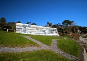 a building on a hill next to a grass field at Redcliffe Apartment L in Bishopston