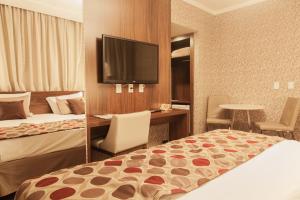 Cama ou camas em um quarto em Class Hotel Pouso Alegre