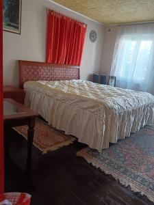 a bedroom with a bed and a red window at B&b Relax / Olga&Claudio in Cassacco