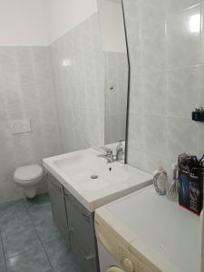 a bathroom with a sink and a toilet and a mirror at B&b Relax / Olga&Claudio in Cassacco +11 photos