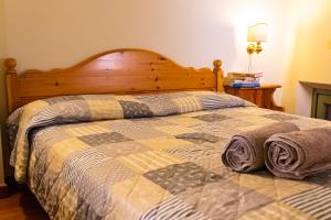 een slaapkamer met een bed met een houten hoofdeinde bij GioHouse4 Apartment in Valeggio sul Mincio